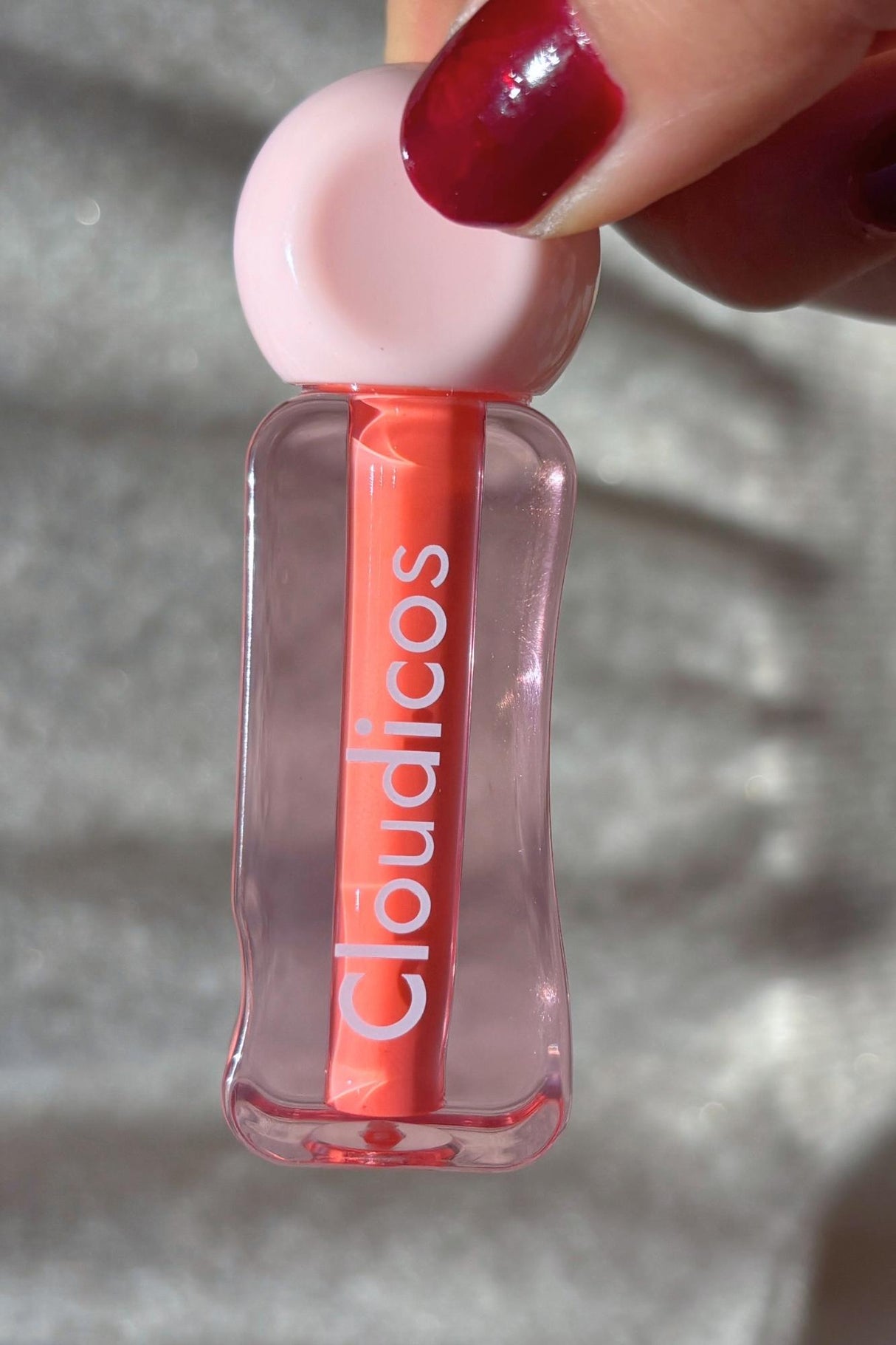 lip stain in peachy colour in the hand