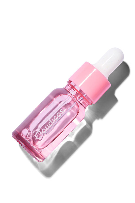 Pink dropper bottle with white cap on a white background