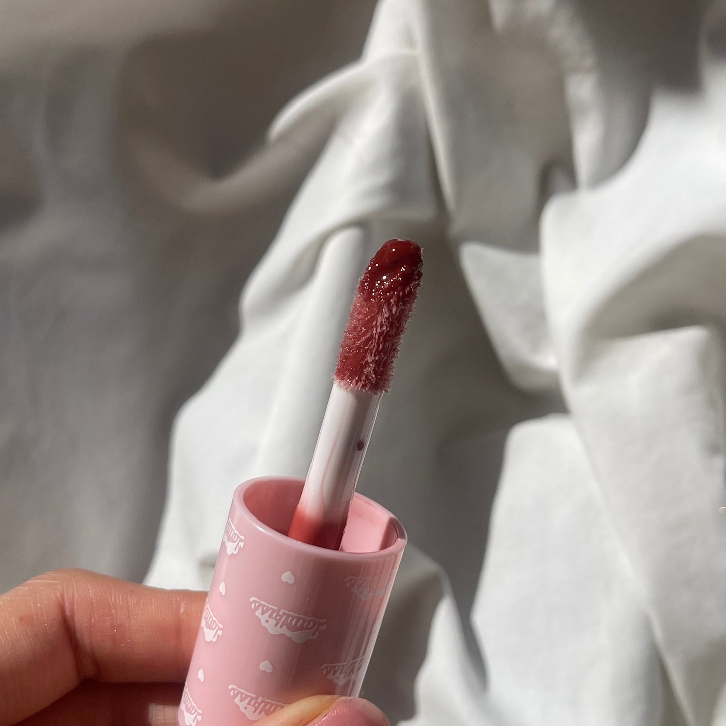 burgundy lip gloss with a big doe foot applicator