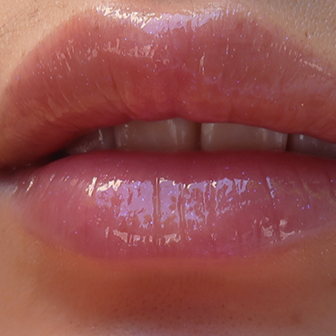 fairydust holographic unicorn pink purple sparkly glitter lip gloss on pale skin swatched on lips
