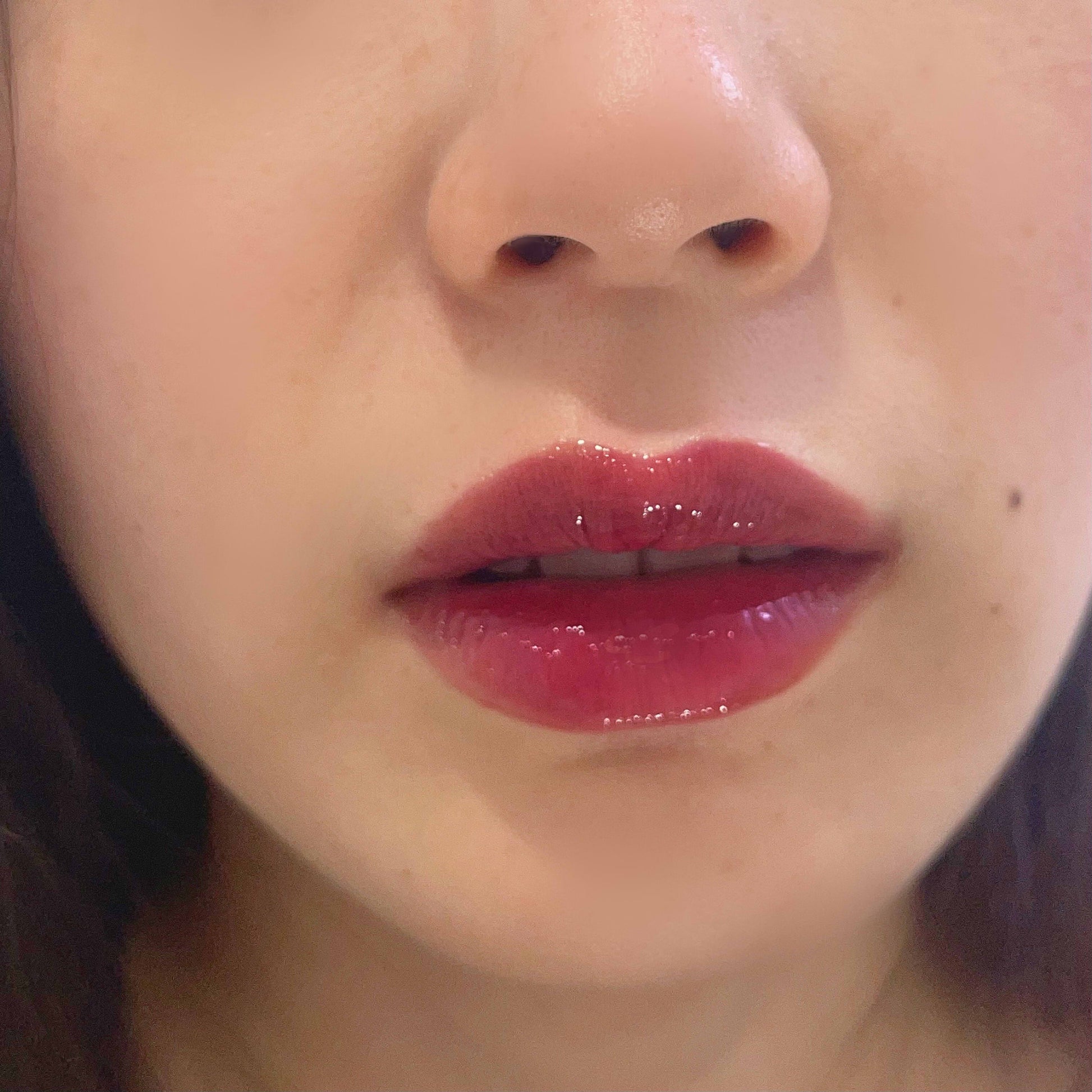 berry grape deep purple jelly sheer lip gloss tube on pale skin lips